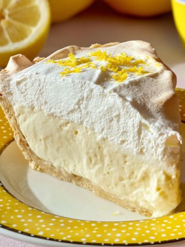 The Best Lemon Angel Pie Recipe 1 A whole slice of Lemon Angel Pie with lemon zest topping, showing the creamy filling and fluffy meringue.