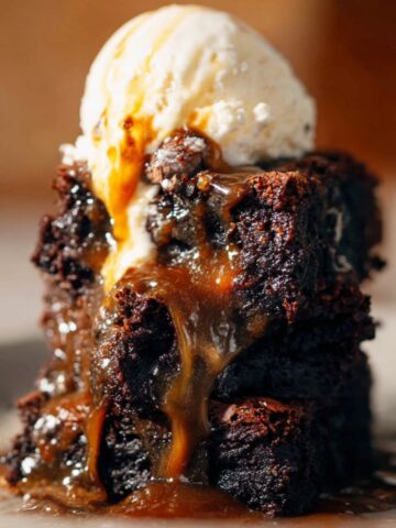 Homemade Salted Caramel Brownies 1 A decadent Salted Caramel Brownies served with a scoop of vanilla ice cream on top, with warm caramel oozing from the brownie.