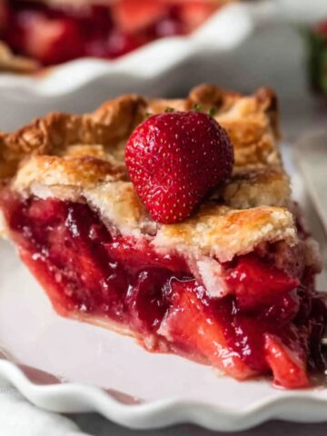 Easy Strawberry Cardamom Rose Pie 1 Slice of Strawberry Cardamom Rose Pie with a fresh strawberry on top.
