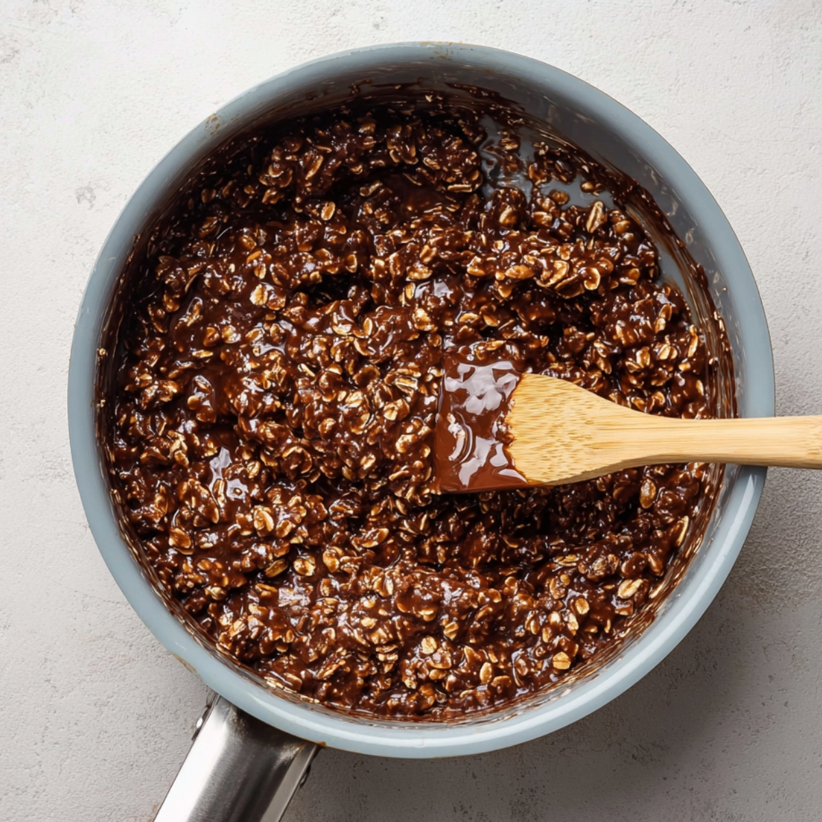 Chocolate Peanut Butter No-Bake Cookies 10 Mixing oats and salt into chocolate peanut butter no-bake cookie mixture in a bowl.