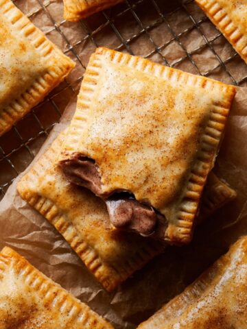 Brown Sugar Cinnamon Pop Tarts 2 Freshly baked Brown Sugar Cinnamon Pop Tarts with golden crust and glossy cinnamon glaze, displayed on a cooling rack.