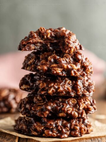 Chocolate Peanut Butter No-Bake Cookies 1 Stack of Chocolate Peanut Butter No-Bake Cookies on parchment paper, rich and glossy with oats.