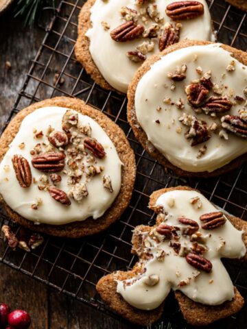 Pecan Sugar Cookies with Brown Butter Icing Recipe 1 Frosted Pecan Sugar Cookies with whole pecans on rustic wire rack