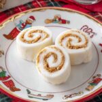 Sliced potato candy pieces on a plate, showcasing the spiral of peanut butter in each slice.