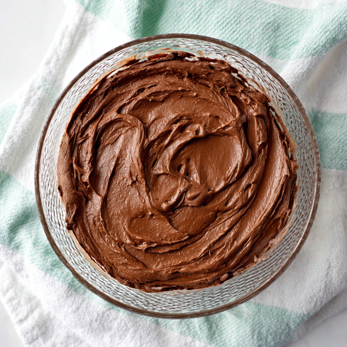 Best French Silk Brownies Recipe 10 Smooth homemade chocolate French silk filling with a rich, creamy texture in a clear glass bowl.