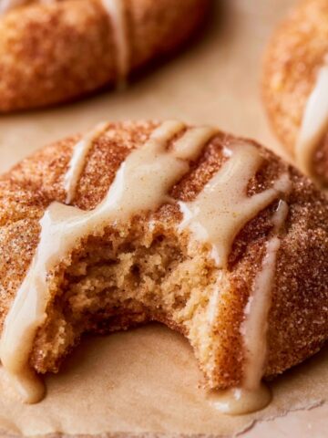 Easy Apple Cider Cookies Recipe 1 Bite taken from a soft Apple Cider Cookies coated in cinnamon sugar and drizzled with creamy vanilla glaze.