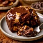 Warm Chocolate Peanut Butter Rolls topped with glossy chocolate frosting and creamy peanut butter glaze, showing a soft, gooey center filled with peanut butter and chocolate.