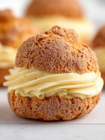 French Choux au Craquelin 1 Classic Choux au Craquelin filled with silky vanilla pastry cream and topped with a crisp craquelin crust.