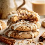 Stack of homemade Coffee Cake Cookies topped with cinnamon streusel and vanilla glaze, with one cookie broken open to reveal the soft center.