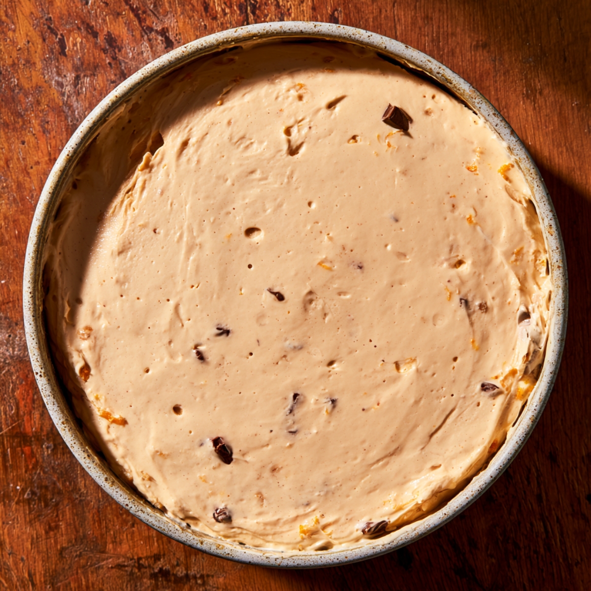 Easy Peanut Butter Butterfinger Pie Recipe 11 Overhead view of creamy peanut butter Butterfinger pie filling smoothed evenly in a round springform pan before chilling.