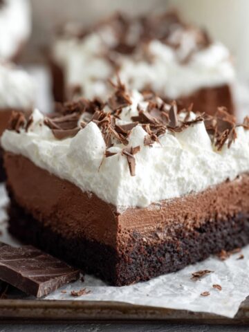 Best French Silk Brownies Recipe 1 French Silk Brownies topped with fluffy whipped cream and chocolate curls over a fudgy brownie base.