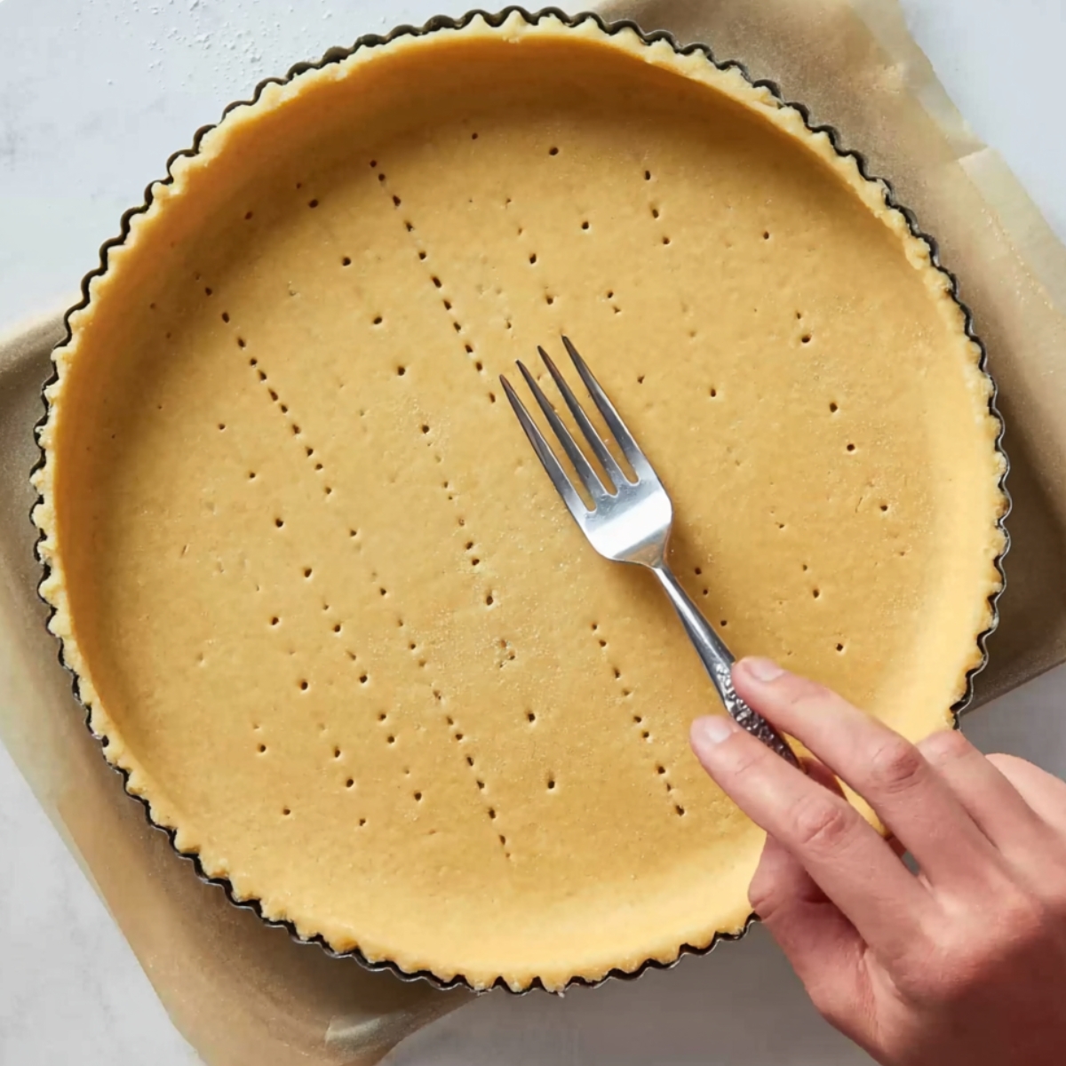 Easy Pistachio Tart Recipe 10 Pistachio tart crust lined in a fluted tart pan and docked with a fork before blind baking.