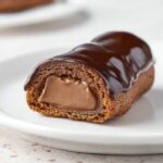Mini Chocolate Éclairs cut in half, filled with silky chocolate pastry cream and coated with glossy chocolate glaze.