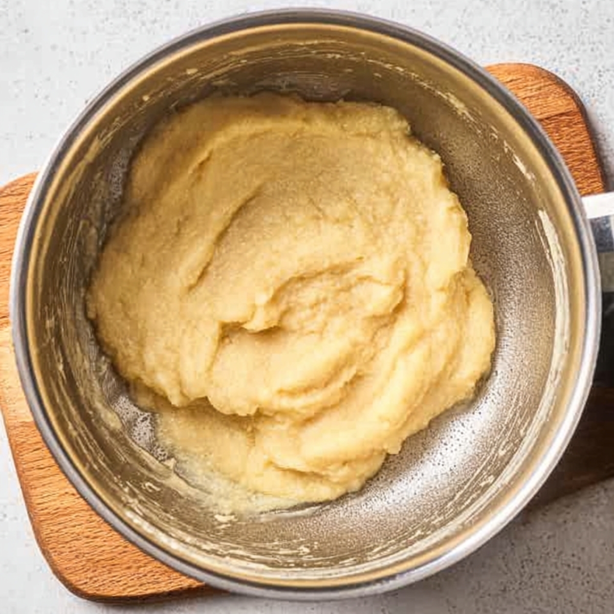 French Choux au Craquelin 10 Freshly cooked choux pastry dough in a saucepan after cooking until smooth and cohesive.