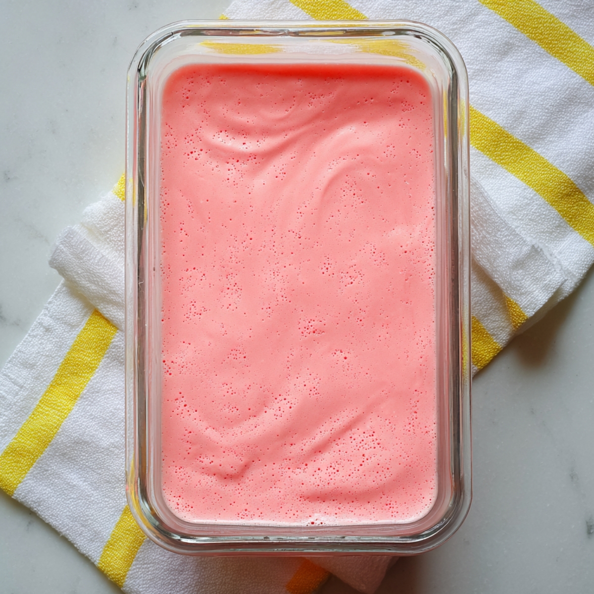 Easy Mexican Milk Jello Recipe 10 Freshly prepared Mexican Milk Jello poured into a glass baking dish before chilling until set.