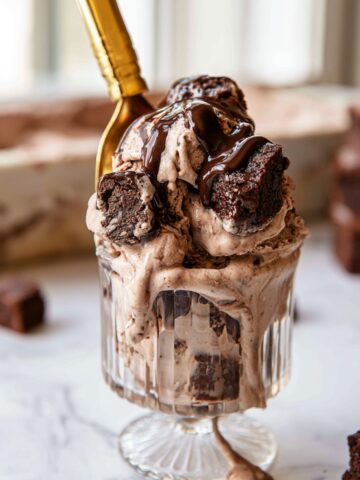 Easy Brownie Batter Ice Cream Recipe 2 Homemade Brownie Batter Ice Cream served in a vintage glass dessert cup with fudgy brownie pieces, chocolate sauce, and a gold spoon.