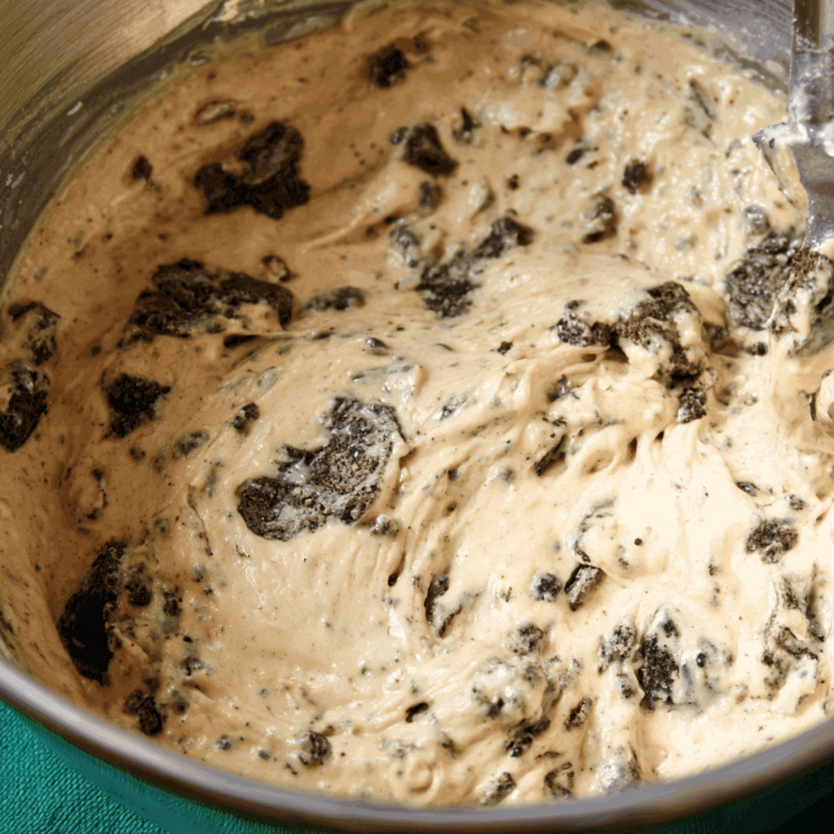 Easy Cookie Monster Cupcakes Recipe 10 Thick cookie cupcake batter mixed with chocolate cookie pieces in a bowl, showing the mix-ins folded into the batter.