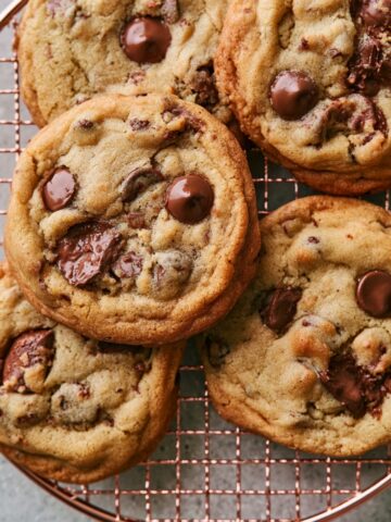 Easy Milk Chocolate Chip Cookies Recipe 2 Freshly baked Milk Chocolate Chip Cookies with melted chocolate pieces on a wire cooling rack