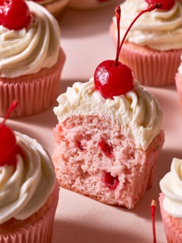 Soft Maraschino Cherry Cupcakes Recipe 2 Homemade pink Maraschino Cherry Cupcakes topped with vanilla buttercream and glossy red cherries.